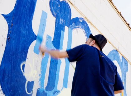 Chank Diesel painting a mural