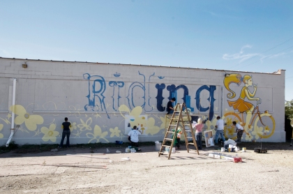 Volunteer painting crew hard at work on a mural